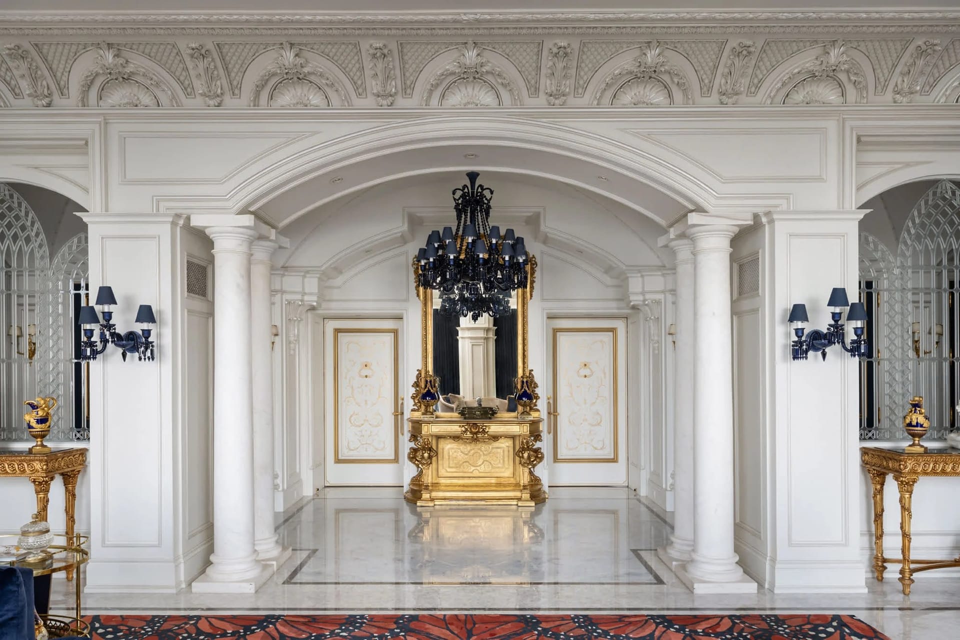 Ornate plasterwork, marble columns and gilded console inside a Toronto estate
