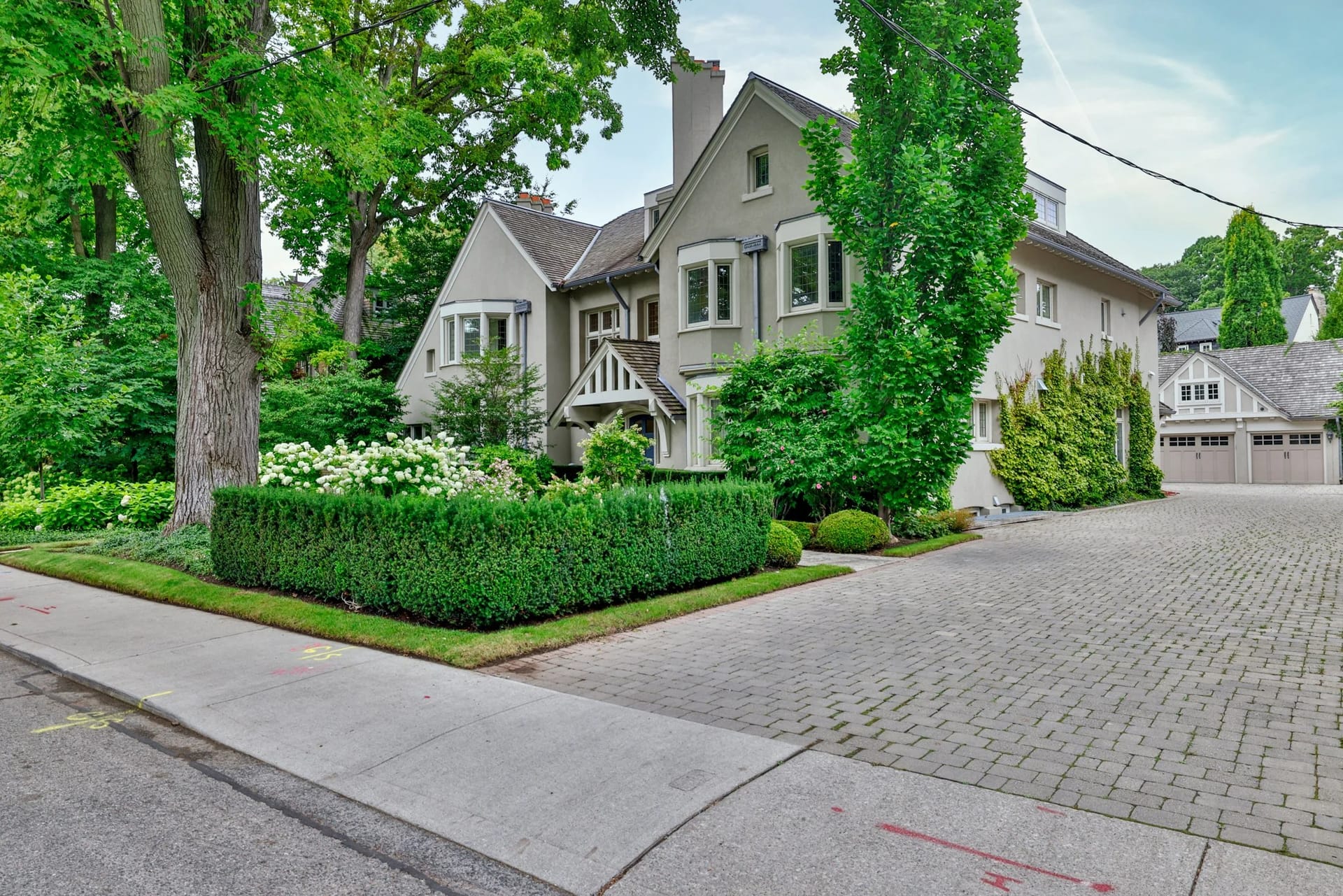 Old-World Architecture residence behind clipped hedges on a cobbled drive